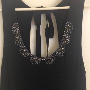 Sleeveless navy dress with beading around neckline